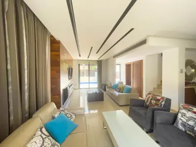 a large living room with couches and a table at Fotini Villas in Protaras