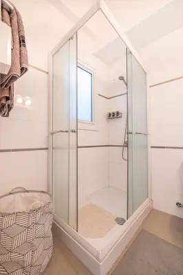 a shower with a glass door in a bathroom at Pageant Homes in Nicosia