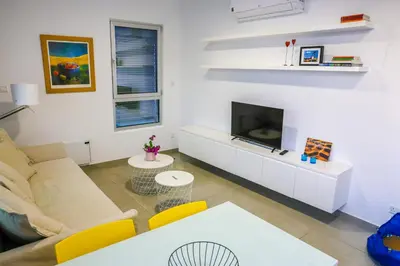 a living room with a couch and a tv at Luxury Stay in Engomi