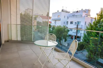 a balcony with a table and two chairs and a window at Luxury Stay in Engomi