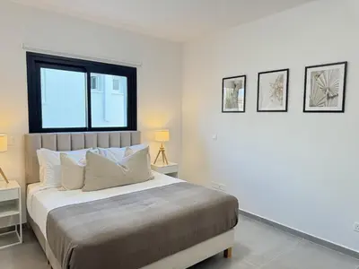 a bedroom with a large bed and a window at Phaedrus Living: White Hills Suites City View in Aglantzia