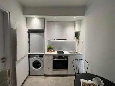 a kitchen with a washing machine and a washer at Cityscape Urban Apts in Nicosia