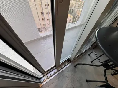 a chair in front of a window with a view at Cityscape Urban Apts in Nicosia
