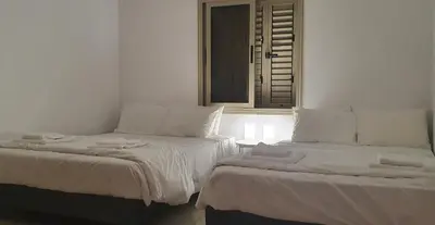 two beds sitting next to each other in a room at BLUE LUXURY APARTMENT (BREAKBOOKING CY-SERVICES LTD) in Limassol