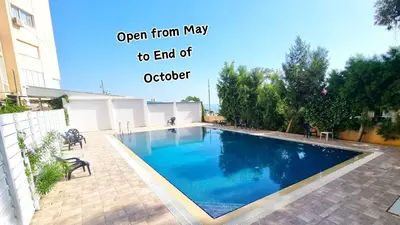 an image of a swimming pool in a yard at Stylish Beach Apt w/ Sea View + Pool + 200Mbit in Larnaka