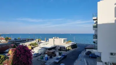 an aerial view of a city with the ocean at Stylish Beach Apt w/ Sea View + Pool + 200Mbit in Larnaka