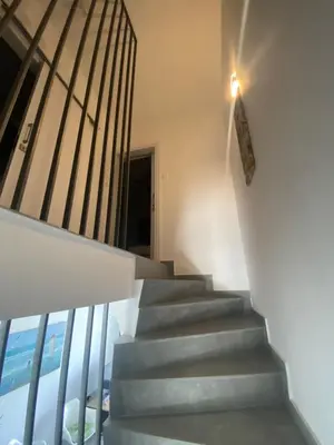 a staircase in a house with a light on the wall at Green Bay Area Apartment in Protaras