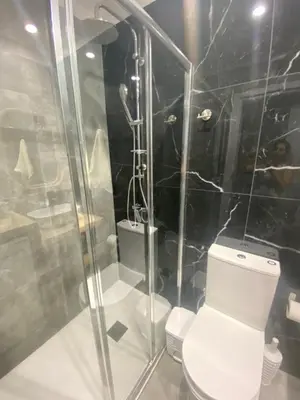 a bathroom with a toilet and a glass shower at Green Bay Area Apartment in Protaras