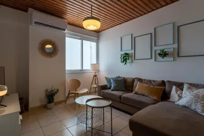 a living room with a couch and a table at Laurel 2-Bedroom Apartment in Larnaca in Larnaka