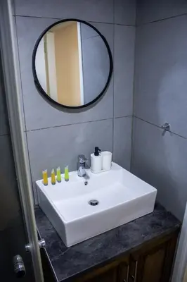 a bathroom with a white sink and a mirror at Αρχοντικό Αλεξάνδρου in Kakopetria