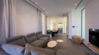 a living room with a couch and a table at Luxury Beachfront Villa - Rooftop Jacuzzi, Sunrise in Paralimni