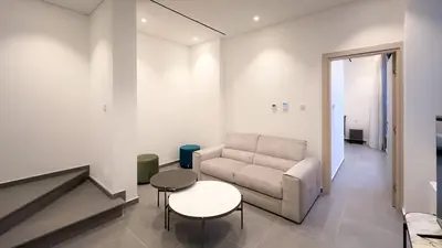 a living room with a couch and a table at Luxury Beachfront Villa - Rooftop Jacuzzi, Sunrise in Paralimni