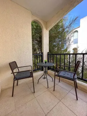 a patio with two chairs and a table on a balcony at Cozy Apartment In Kapparis in Paralimni