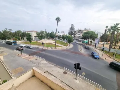 a view of a city street with cars on the road at Larnaca Garden Rooms in Larnaka