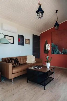 a living room with a couch and a table at Zima Edge in Parekklisha