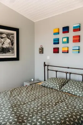 a bedroom with a bed and some pictures on the wall at Zima Edge in Parekklisha