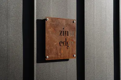 a metal plate on a door with the words zima adjective at Zima Edge in Parekklisha