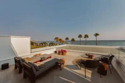 a living room with a view of the ocean at Kaliva Suites - Adults Only in Ayia Napa