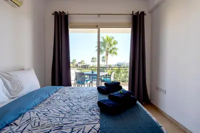 a bedroom with a bed and a view of a patio at Limassol Star 21 in Limassol
