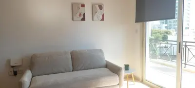 a living room with a couch and a window at Limassol Star 21 in Limassol
