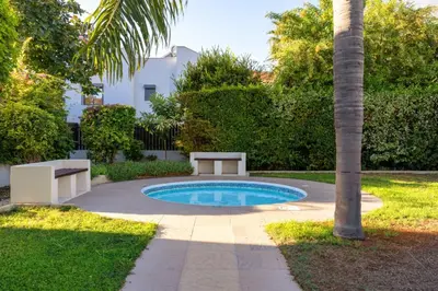 a small pool with a picnic table and a palm tree at Limassol Star 21 in Limassol