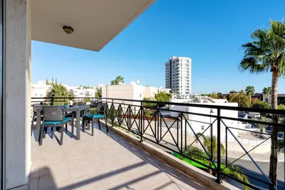 a balcony with a table and a view of a city at Limassol Star 21 in Limassol