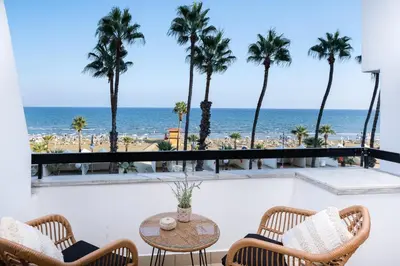 a balcony with a table and chairs and the ocean at Quattro Beachfront Sea View Ap 206 in Larnaka