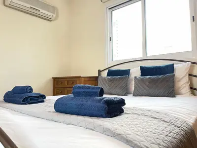 a bedroom with a bed with blue towels on it at Anastasia Holiday Apartment Larnaca in Larnaka