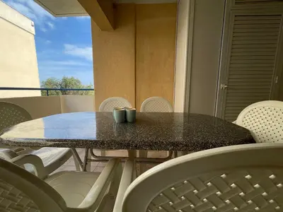 a table with two mugs on it on a balcony at Anastasia Holiday Apartment Larnaca in Larnaka