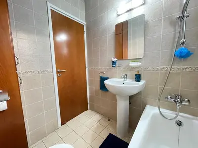 a bathroom with a sink and a toilet and a shower at Anastasia Holiday Apartment Larnaca in Larnaka