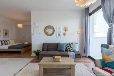 a living room with a couch and a table at Livia Studio Apartment in Larnaca in Larnaka