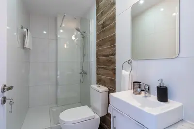 a bathroom with a toilet and a shower and a sink at Livia Studio Apartment in Larnaca in Larnaka