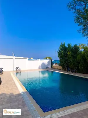 a swimming pool on the side of a building at Sea the Sunrise in Larnaka