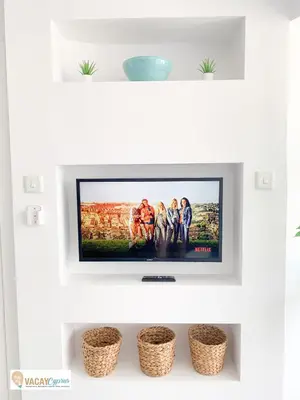 a flat screen tv sitting on top of a shelf at Sea the Sunrise in Larnaka