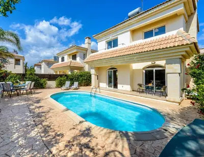 a swimming pool in front of a house at Villa Oscar in Protaras