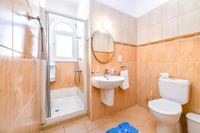 a bathroom with a toilet and a sink and a shower at Villa Oscar in Protaras