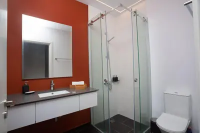 a bathroom with a sink and a glass shower at Bridge House 201 - 3BR Penthouse in Limassol