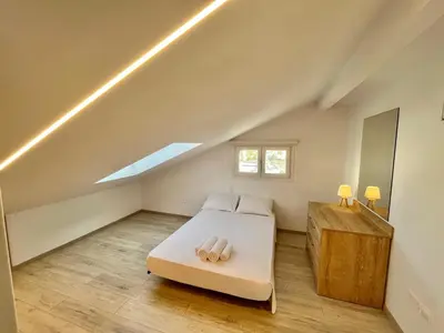 a bedroom with a bed in a attic at Trendy Loft Apartment in Limassol
