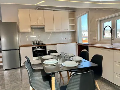 a kitchen with a table and chairs in a kitchen at Trendy Loft Apartment in Limassol