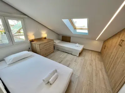 a attic bedroom with two beds and a skylight at Trendy Loft Apartment in Limassol