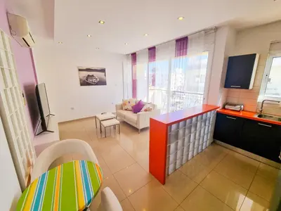 a room with a kitchen and a living room at City Vibrance Apartment in Larnaka