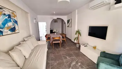 a living room with a couch and a table at Center 2Br Apt w/ parking and 250m walk from beach in Larnaka