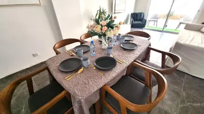 a dining table with plates and utensils on it at Center 2Br Apt w/ parking and 250m walk from beach in Larnaka