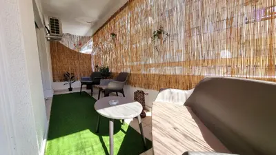 a room with a couch and a table and green carpet at Center 2Br Apt w/ parking and 250m walk from beach in Larnaka
