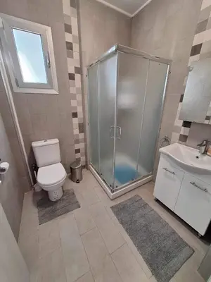 a bathroom with a shower and a toilet and a sink at Marianna's House in Galata