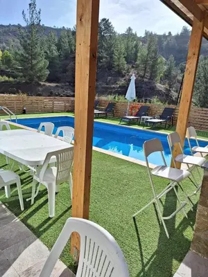 a table and chairs next to a swimming pool at Marianna's House in Galata