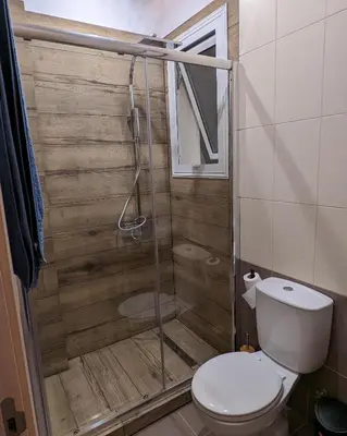 a bathroom with a toilet and a glass shower at Luxury 2-Bedroom Apt. with Seaview in Protaras