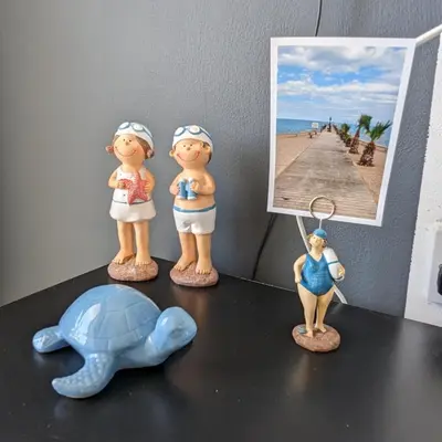 a group of figurines on a table with a turtle and a picture at Luxury 2-Bedroom Apt. with Seaview in Protaras