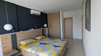 a bedroom with a bed with a yellow and blue comforter at Luxury 2-Bedroom Apt. with Seaview in Protaras