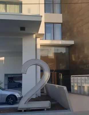 a statue of a letter z in front of a building at Deluxe 1 Bed Apt Ayios Dometios in Ayios Dhometios